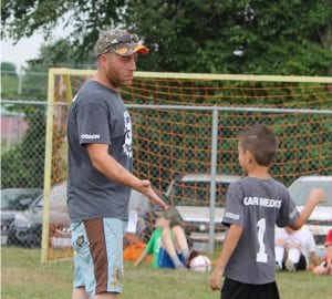 Coach Giving High Five To Player
